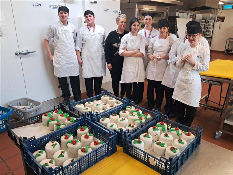 Nicola Thomson-Dewey and Catering students with the Christmas cakes they have made for The Christmas Dinner for Care Leavers Barnsley.