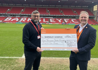 Darren Hayes handing over the cheque to the hospice’s Simon Atkinson.