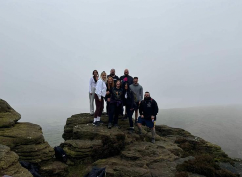 Staff at the summit of Kinder Scout.