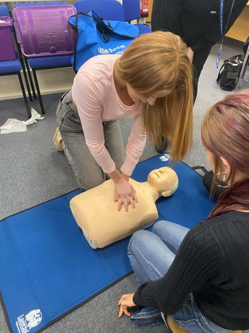 Young people take part in hands-on first aid training with expert trainers from Crossroads.