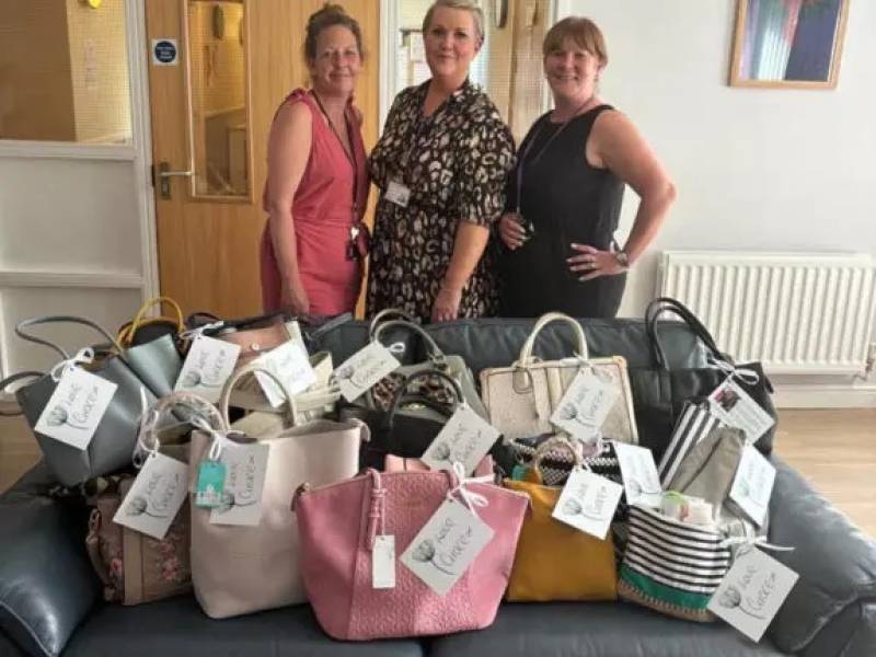 IDAS representatives and Nicola Thomson-Dewey (centre) with bag donations for IDAS.